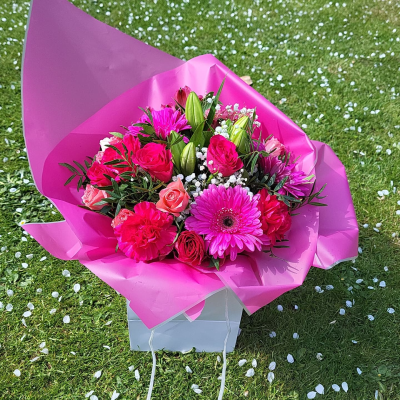 Pretty Pinks - Handtied of mixed pink flowers and lush green foliage in a nice bag