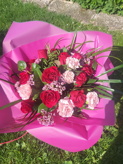 Roses and Carnations - Handtied of mixed pink roses and carnations in a handtied. Will be in a box or a bag