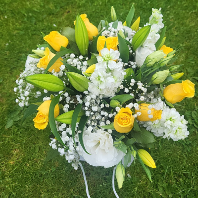 Mellow Yellow - An arrangement pf yellow roses and white lillies mixed filled flowers in a container of the florists choice