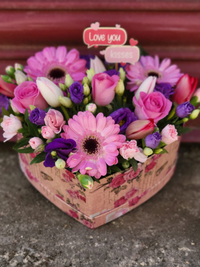Heart Hatbox - Small heart shaped hat box arrangement in shades of pinks, purples and whites to include gerbera and roses.