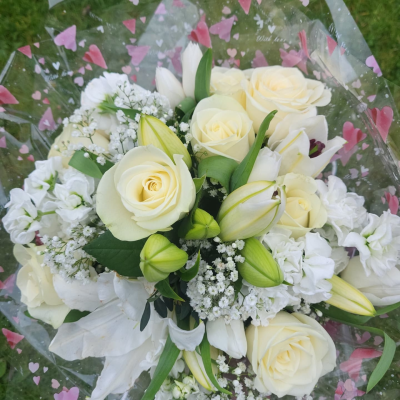 Serenity - Handtied of white roses and lillies with mixed filler flowers in a nice box or bag